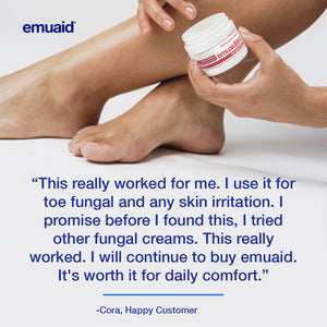 customer holding jar emuaid cream next to bare feet
