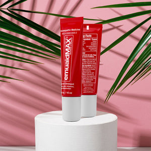 red emuaidmax ointment tubes on pink background