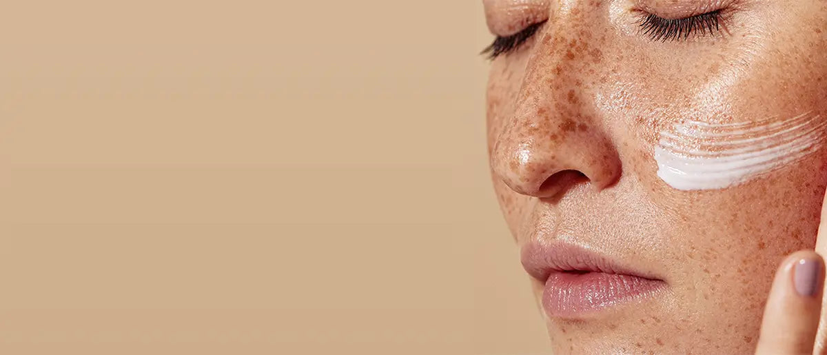 woman applying skincare cream