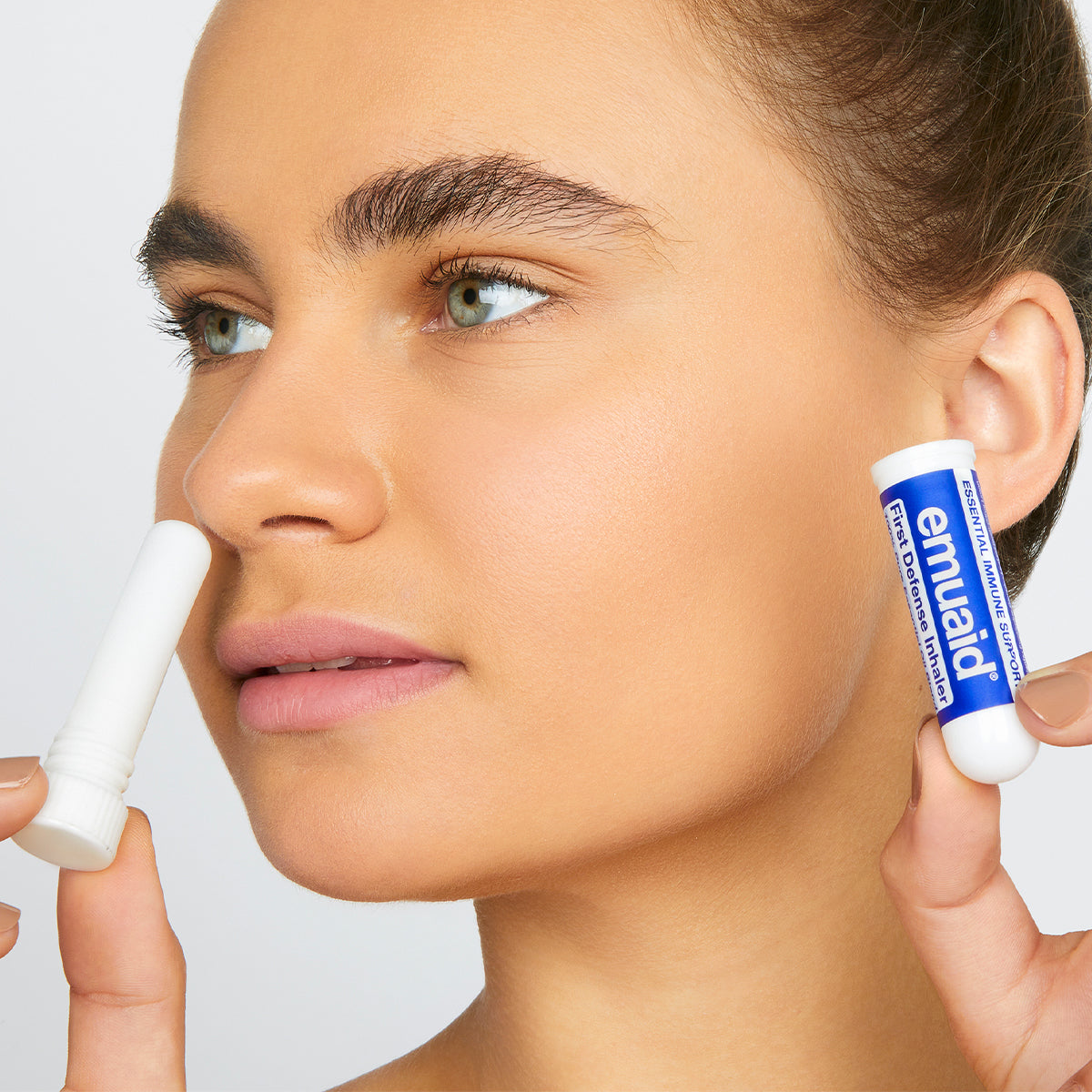 woman using essential immune support inhaler